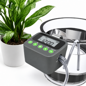 Digital irrigation timer beside potted indoor plant